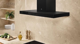 Wall-mounted cooker hoods in a kitchen.