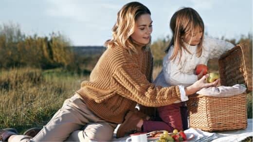 Woman and girl having picnic