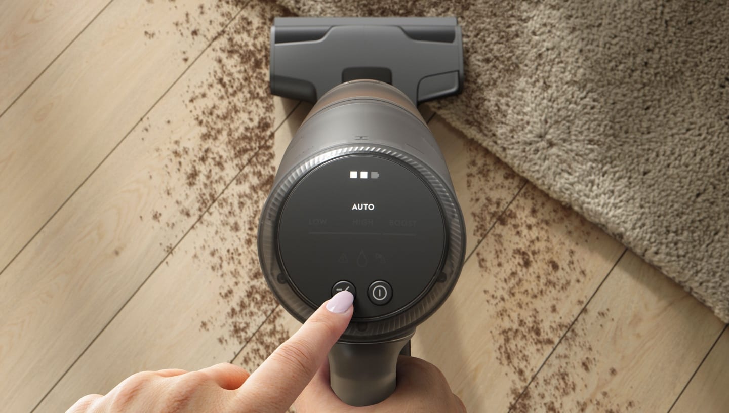 View from top of a vacuum cleaner cleaning a dirty floor.