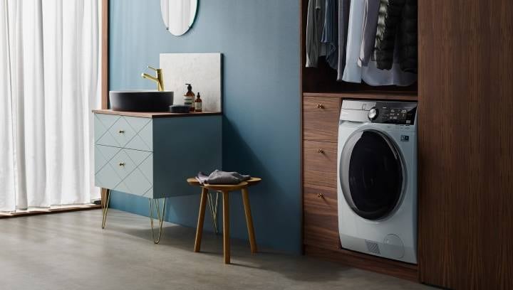 A built-in washer-dryer in a stylish and modern bathroom